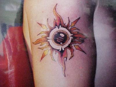 Flaming sun symbol tattoo