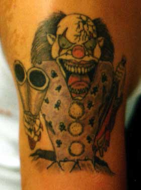 Insane clown with shotgun tattoo