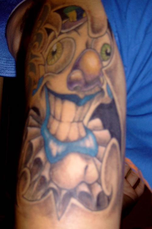 Crazy  colourful clown arm tattoo
