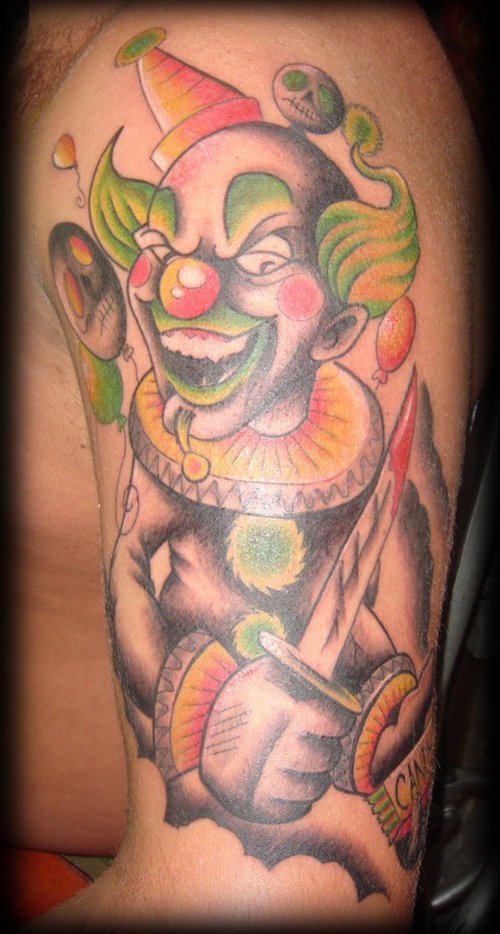 Evil clown with dagger coloured tattoo