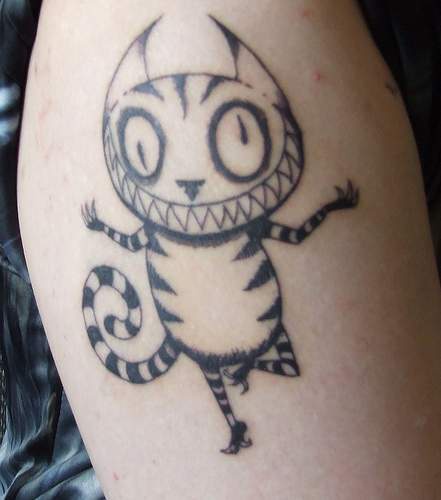 Crazy smiling cat black ink tattoo