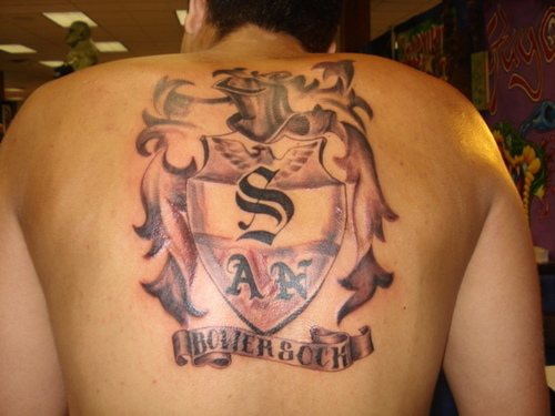 Heraldic shield tattoo on back