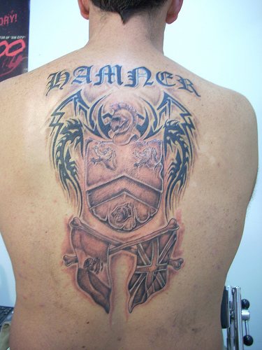 Large family crest damned tattoo on back