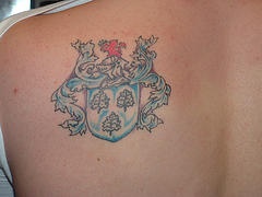 Blue heraldic emblem tattoo