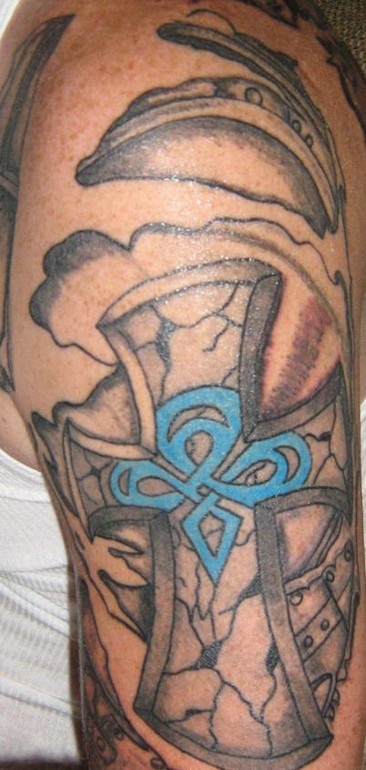 Celtic style cross sleeve tattoo