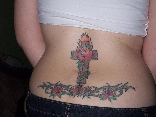 tatuaje en el bajo de la espalda de cruz con rosas