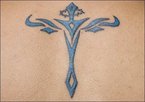 Minimalistic blue cross tattoo