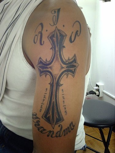 Heraldic cross memorial arm tattoo