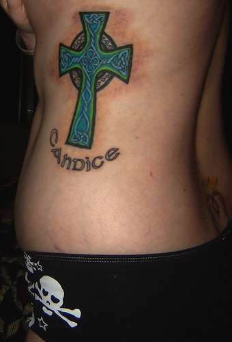 Celtic style cross tattoo on side