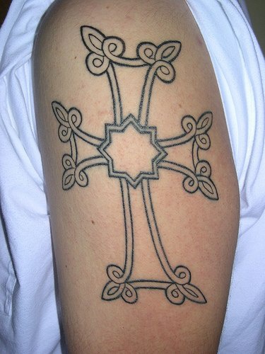 Cross tracery tattoo on arm