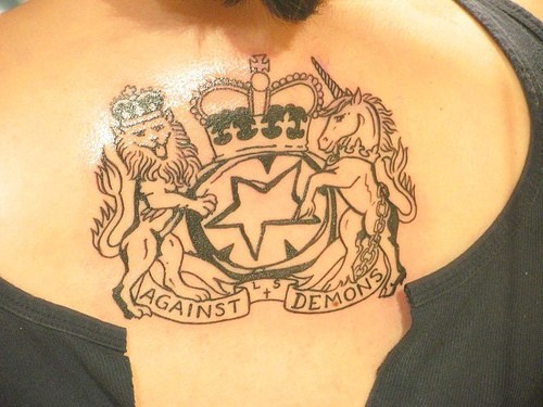Heraldic lion and unicorn with large crown tattoo