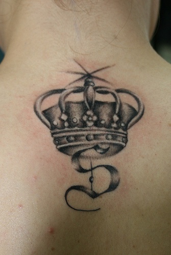 Crowned monogram black ink tattoo