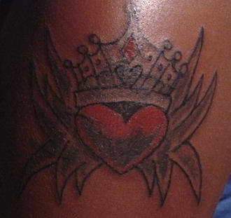 tatuaje de corazón coronado con puas