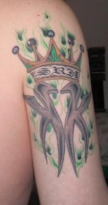 Kk in crown on green flames tattoo