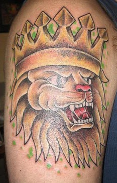 Lion in crown coloured tattoo