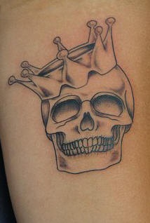Skull in crown black ink tattoo