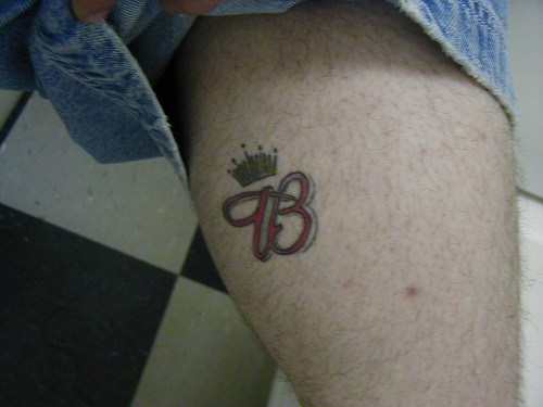Budweiser crown tattoo on leg