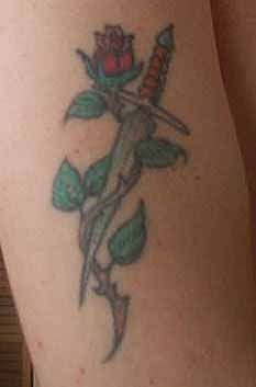 Stiletto with rose around tattoo