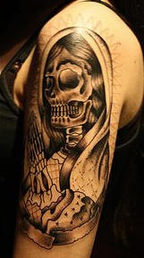 Praying death tattoo on arm