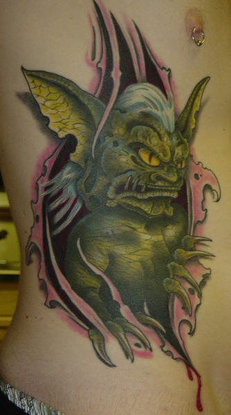 Green demon under skin rip tattoo