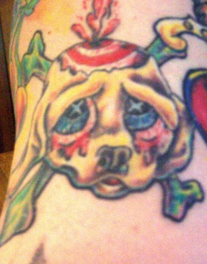 Guilty look doggy with bones tattoo
