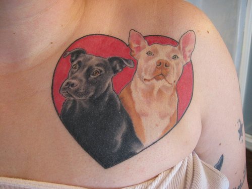 Two dogs in heart coloured tattoo