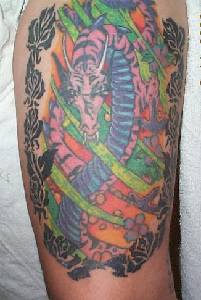 Colourful hydra dragon in roses tattoo