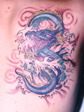 Sharp toothed blue dragon in sea tattoo