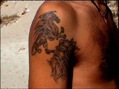Dragon fight shoulder tattoo