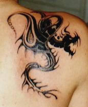 Tribal dragon shoulder tattoo