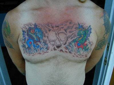 Blue and green dragons with full moon tattoo on chest