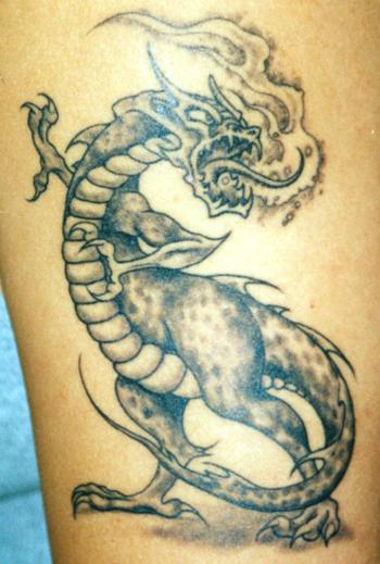 Roaring dragon black ink tattoo