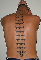 Tribal backbone black ink tattoo