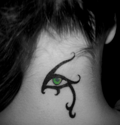 Tribal style green eye tattoo on neck