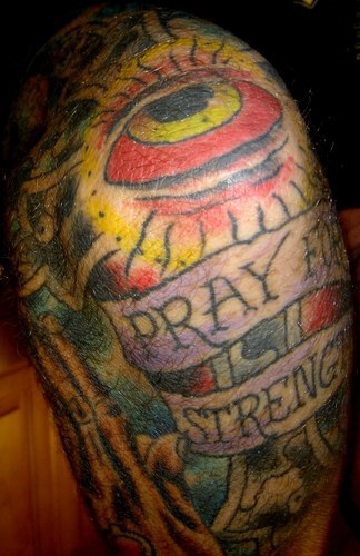 Pray in strength red eye tattoo