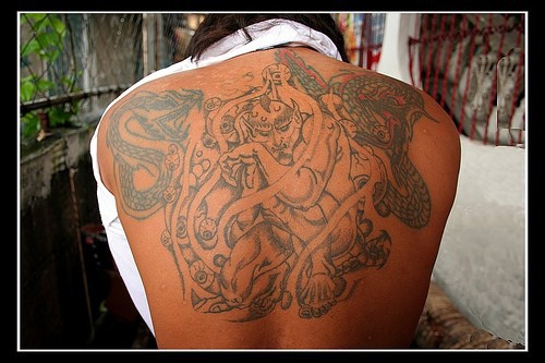 Sitting demon full back tattoo