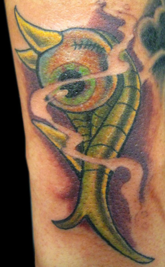 Green demonical eye tattoo