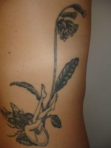 Black and white little fairy under flower tattoo
