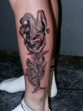 Evil buffoon on tribal tattoo