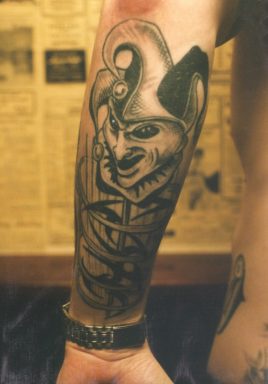 Dark fantasy buffoon sleeve tattoo