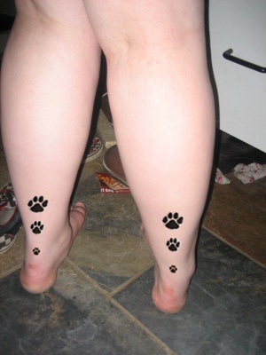 Cat paw prints tattoo on both legs