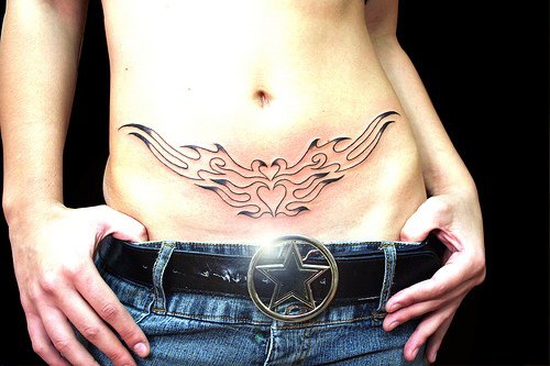 Female stomach tattoo, two white birds, fusion