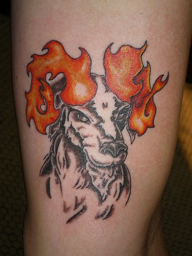 Goat with fire horns tattoo