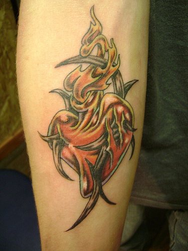 Heart in flame tribal tattoo