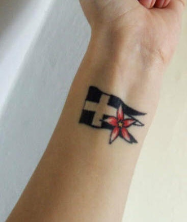 Flag and flower wrist tattoo