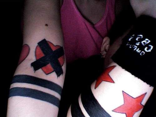Simple black and red wrist tattoo