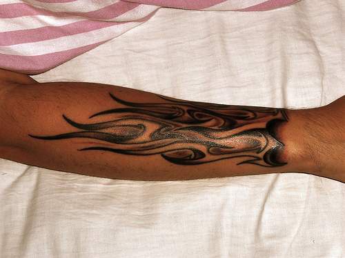 Long flames arm tattoo