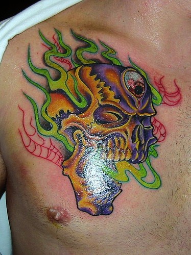 Flaming skull chest tattoo