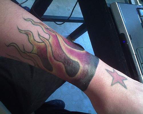 Flaming arm sleeve tattoo