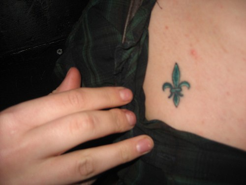 Small fleur de lis tattoo on chest